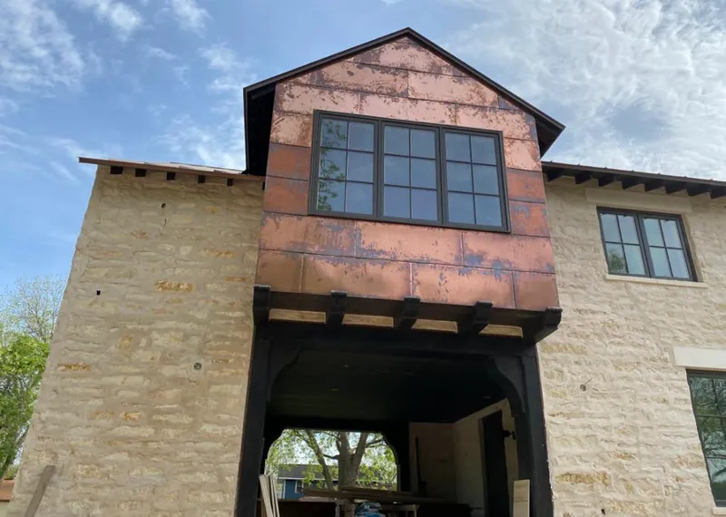 Copper metal panel facade on a stone building for Metal Roof Coating in Aspen