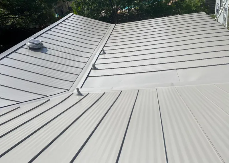 Solar attic fan installed on a metal roof for Roof Ventilation in Aspen
